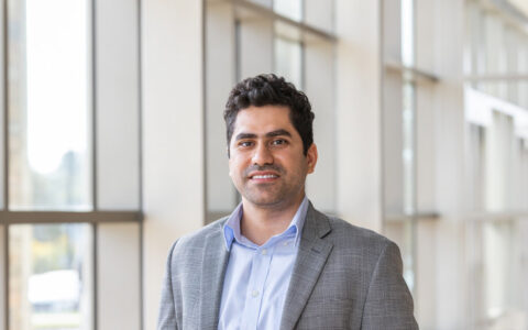 Portrait of professor with NSF grant for AI and solar power integration.