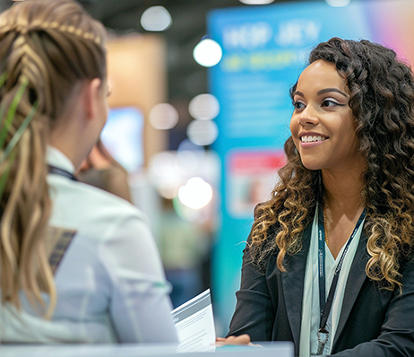 Photograph of two people wearing business attire interacting during an interview
