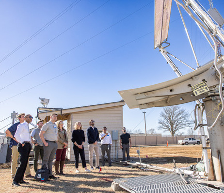 Photograph of UTulsa students learning about a large piece of equipment at UTulsa's North Campus