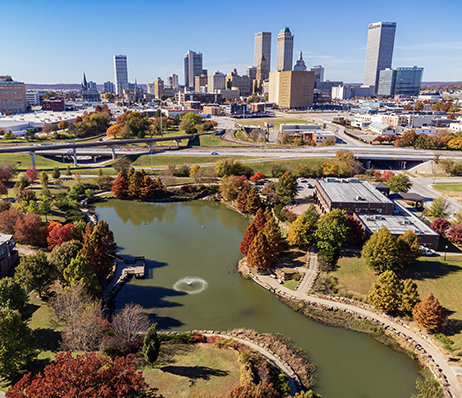 Photograph of a city landscape with neighborhoods in the foreground and skyscrapers on the horizon
