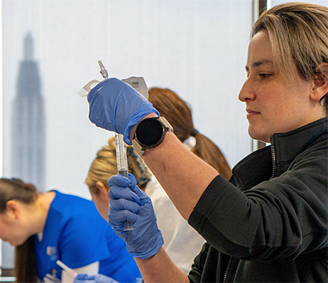 Photograph of a nurse preparing a syringe