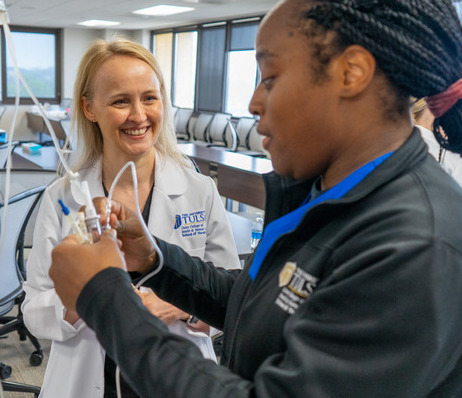 Photograph of two nurses preparing an I.V.