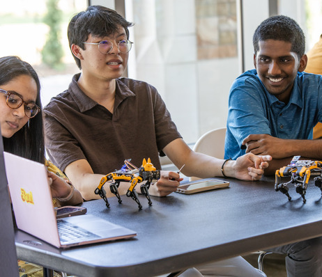Photograph of TU students with robotics research.